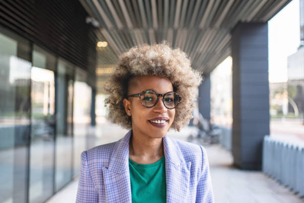Portrait of African American businesswoman leader, boss of modern creative company outside the office Portrait of African American businesswoman leader, boss of modern creative company outside the office half shaved hairstyle stock pictures, royalty-free photos & images