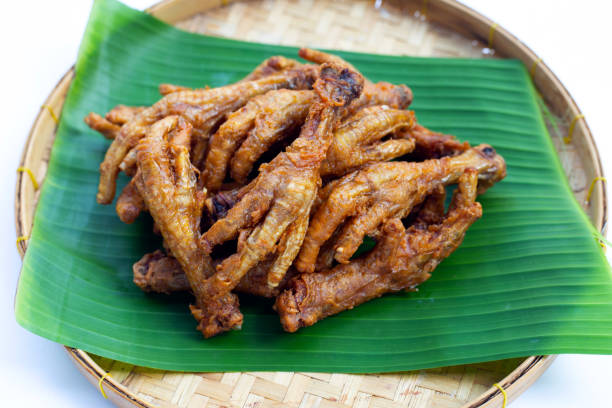 istock Fried chicken feet in bamboo basket on white background. 1385559311