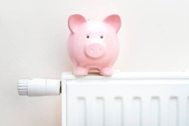 istock Piggy bank on radiator. Heating cost concept 1385562074