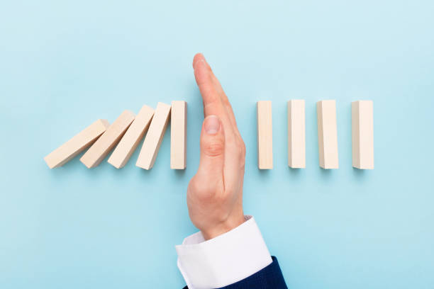 istock Domino business risk, crisis effect concept 1385563673