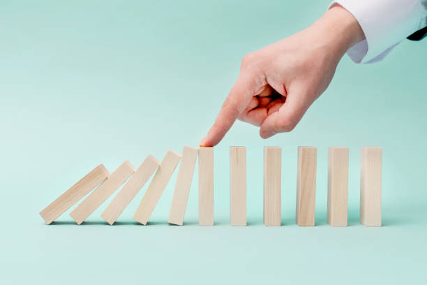 istock Domino business risk, crisis effect concept 1385563686