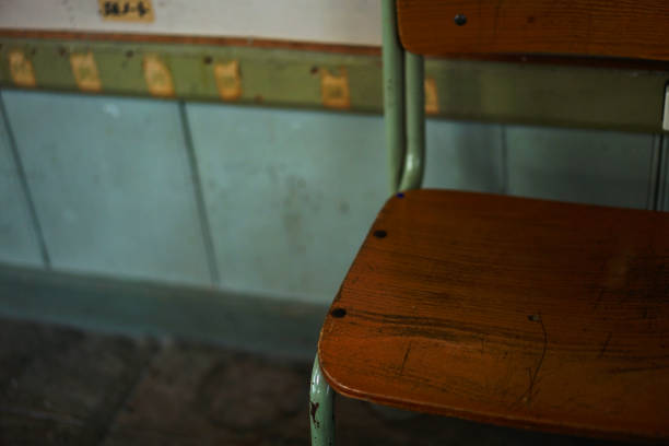 A chair placed in an old elementary school classroom