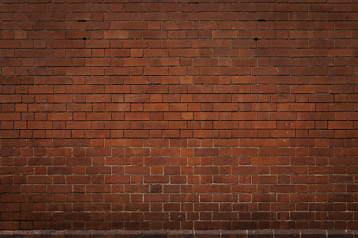 Section of an old red brick wall.