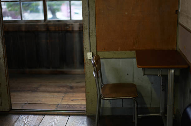 istock Desks and chairs in an old elementary school classroom 1385563821