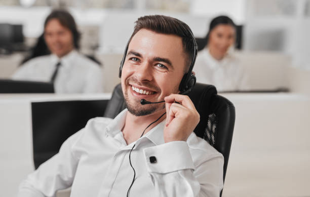 Positive operator with headset answering phone call stock photo