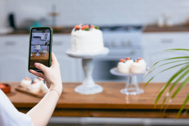 istock Pastry chef confectioner young caucasian woman with cake on kitchen table. 1385568924