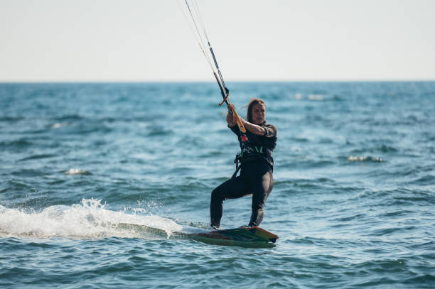 istock Woman kitesurfing on the ocean waters 1385570737