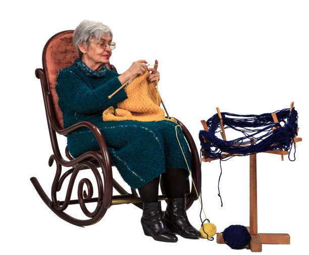 Image of an old woman sitting on a rocker and knitting, isolated against a white background.