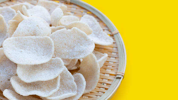 istock Prawn crackers on yellow background. Shrimp crispy rice snack 1385578404