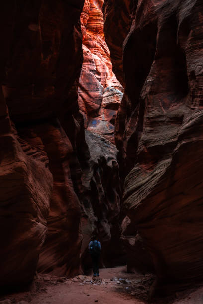 istock Hiker Stands Looking Up Toward The Light In Buckskin Gulch 1385581063