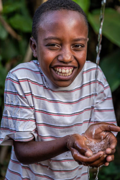 istock African young boy drinking fresh water, East Africa 1385594343