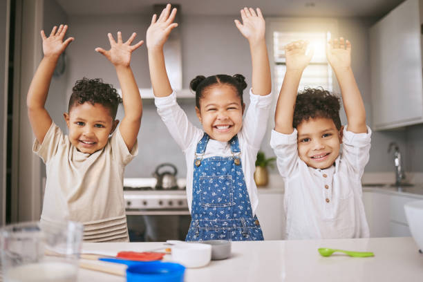 istock Shot of three cheerful siblings celebrating while baking in a kitchen 1385595630