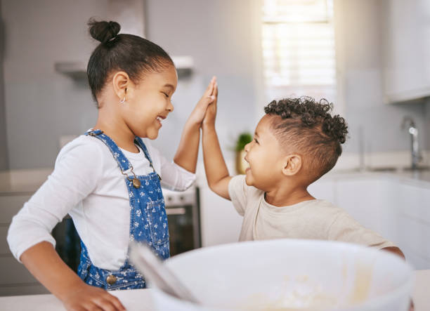 istock Shot of a brother and giving a high five while baking in a kitchen 1385595642