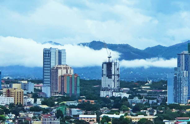 istock Cloudy city view overlooking the mountains at Manhattan Cubao 1385598988