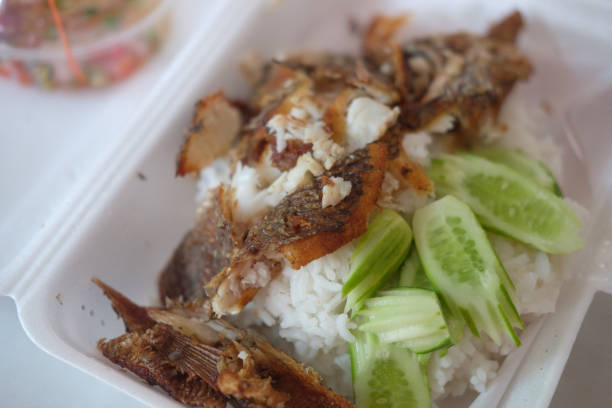 Deep-fried tilapia fish served on steam rice, the popular menu with trader remove the fishbone for customer easy to eat