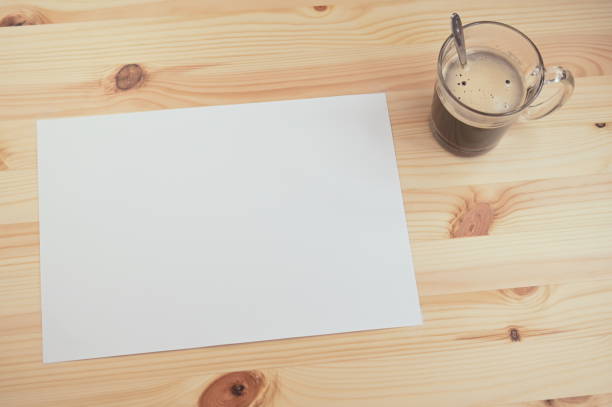 istock white paper on wood table with coffee 1385602634