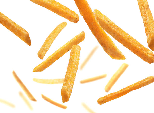 French fries levitate on a white background stock photo