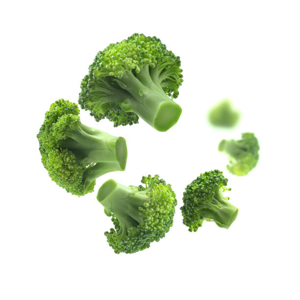 Green broccoli levitating on a white background stock photo