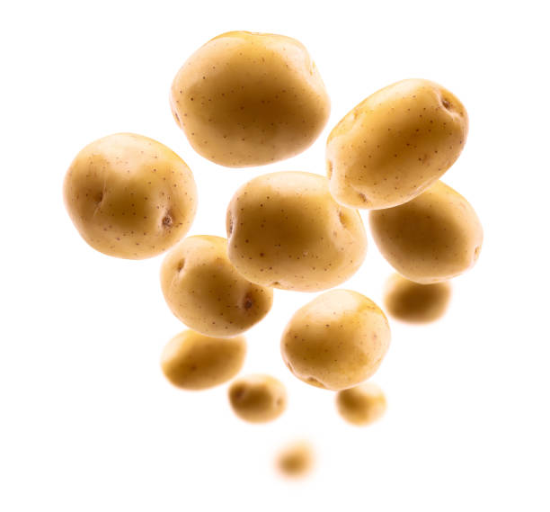 istock Golden potatoes levitate on a white background 1385603401