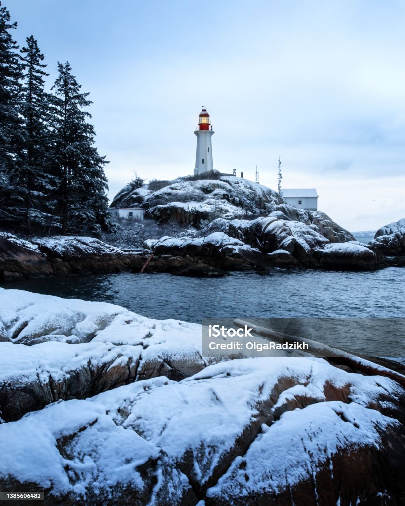 Winter in Vancouver A winter scene at the beach during the cold snap in Vancouver, BC. Atkinson Point lighthouse is seen on the rock. Beach Stock Photo