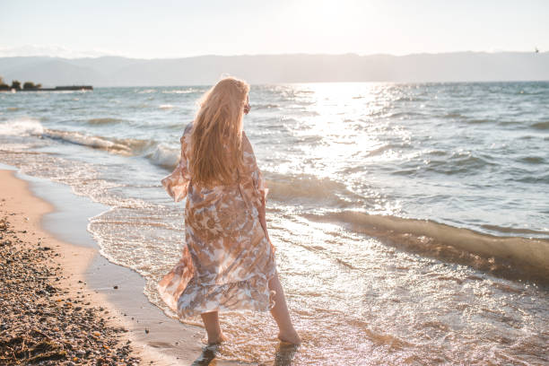 istock Rear view of a confident plus size woman on the beach 1385606565