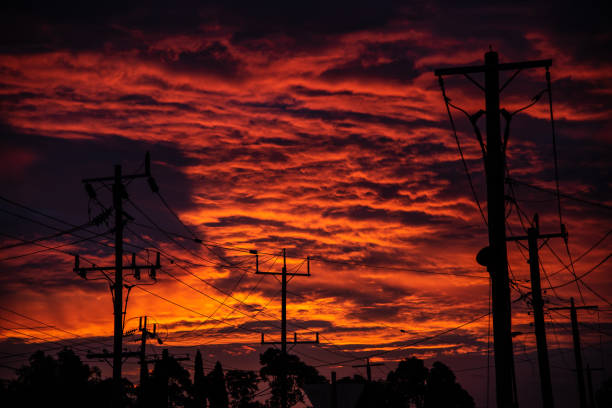 istock Power lines are in silhouette against a blood red sky 1385607252