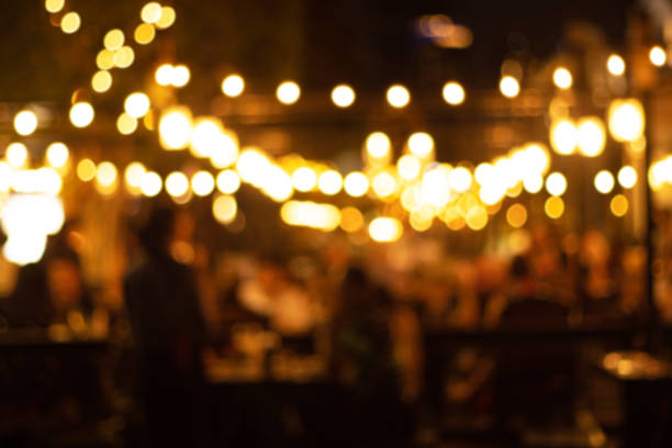 blurred image at the restaurant night time, many people in the restaurant eat and party happy relaxing stock photo