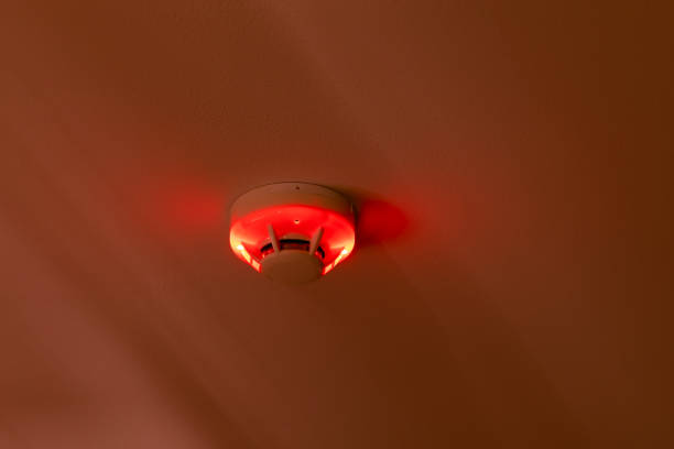 smoke detector fire alarm setup mount at condominium or apartment room ceiling activated red light