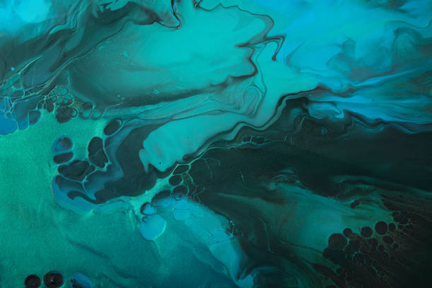 istock Fluid Art. Metallic Green and blue abstract wave swirls on black background. Marble effect background or texture 1385612408