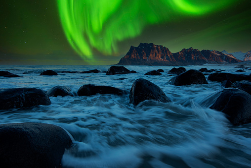 Aurora rising above a beautiful mountain. In iceland