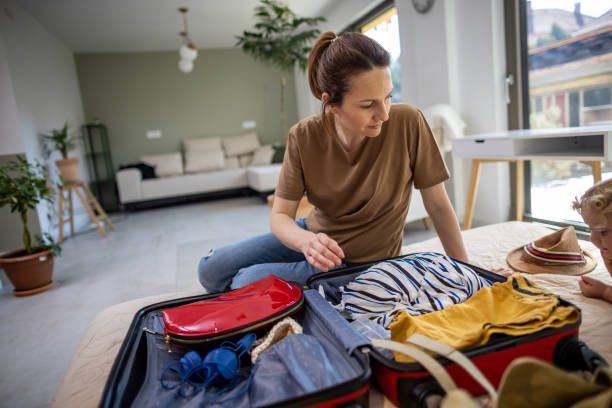 istock Woman packing suitcase for a trip 1385615936