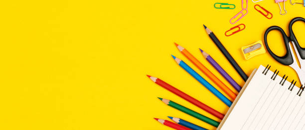 istock Top view notebooks and accessories studying in the library at school yellow background idea education 1385618539