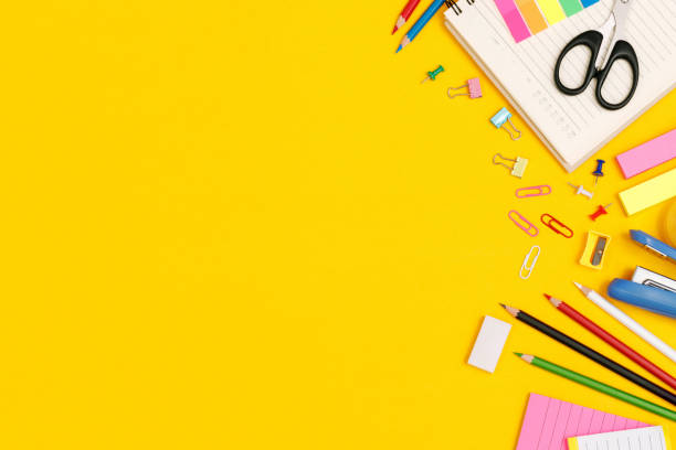 istock Top view notebooks and accessories studying in the library at school yellow background idea education 1385618549