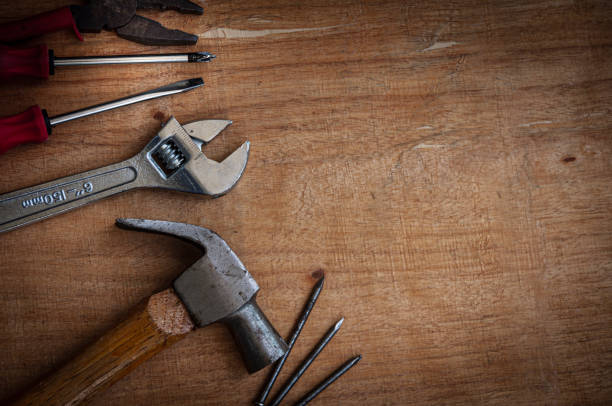 istock Top view of working tools on wooden desk. 1385620714
