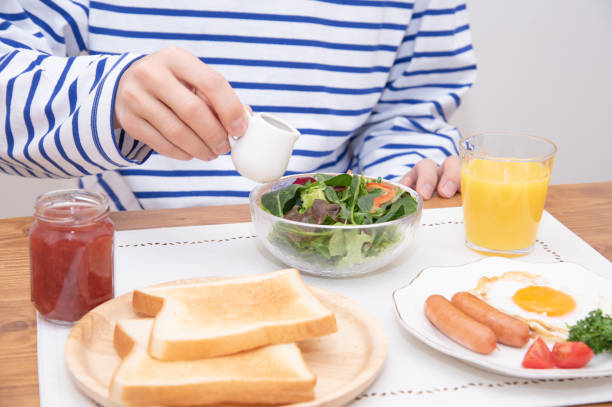 Asian man dressing salad