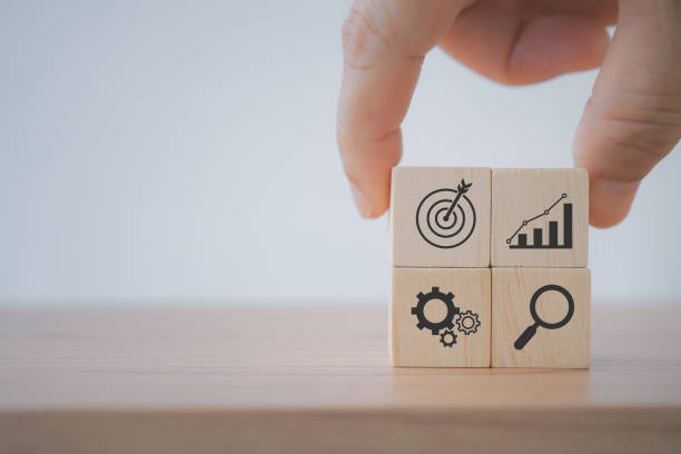 istock Hand putting print screen increasing graph and target dartboard wooden cube with magnifier glass  and gear for target of investment and business concept 1385622003