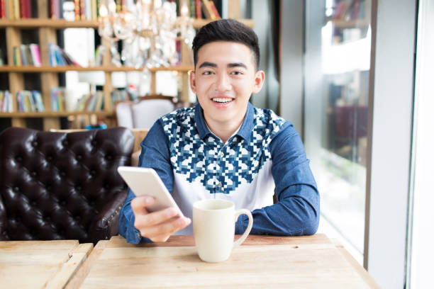 istock young handsome man in coffee shop 1385623163