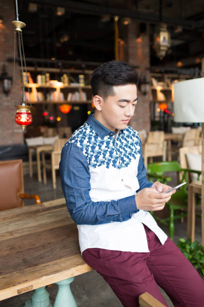 istock young handsome man in coffee shop 1385623175