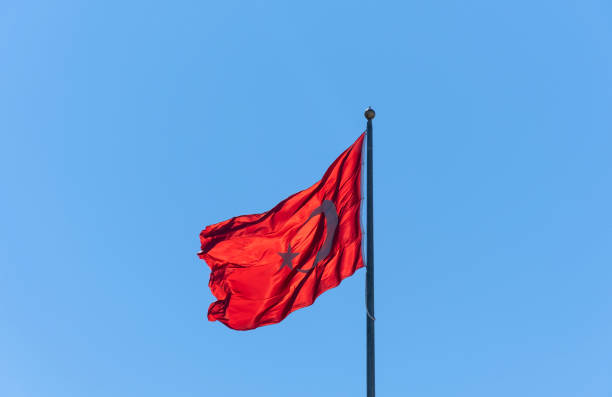 istock Turkish flag waving in the blue sky. Flagpole. 1385623391