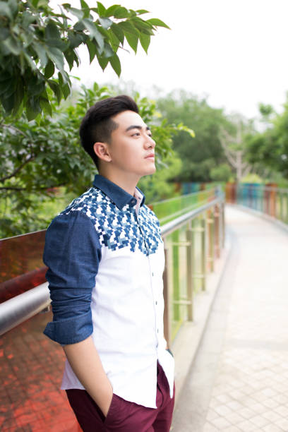 istock young handsome man in the park 1385624128