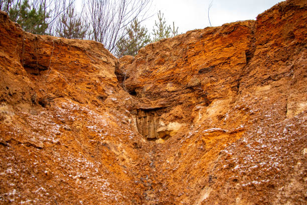 istock Textural sand, with  relief surface, multi-colored layers and different in size of granules, in outdoor sand career, after mining ore and sand for construction. 1385624505