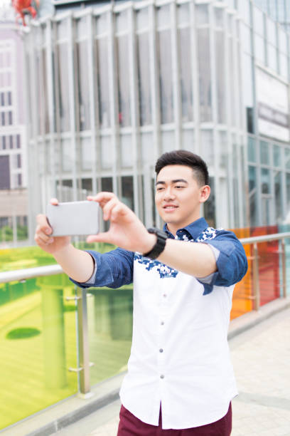 istock young handsome man in the park 1385624547