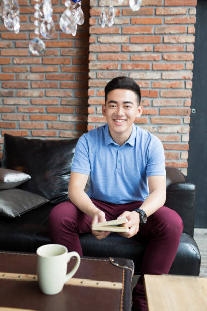istock young handsome man in coffee shop 1385625250