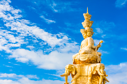 White pagoda with Buddha statue in Phrathat Doi Leng temple, Thailand.