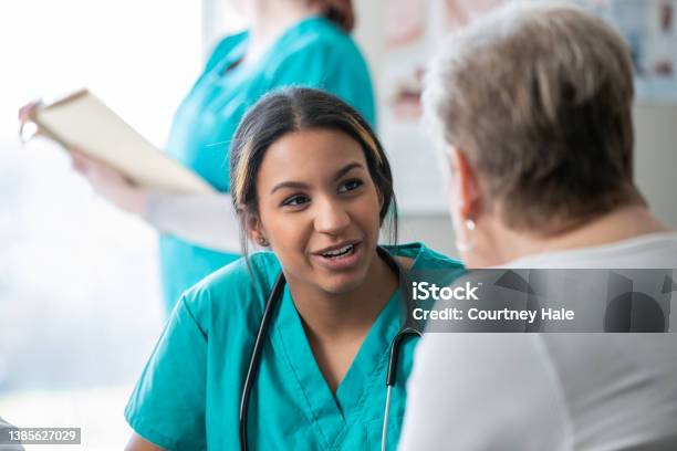 Cancer Patient Meets With Diverse Group Of Doctors Nurses And Healthcare Providers In Hospital To Discuss Treatment Plan Stock Photo - Download Image Now