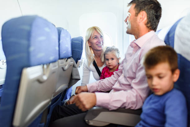 istock Happy family talking while traveling by plane. 1385627987