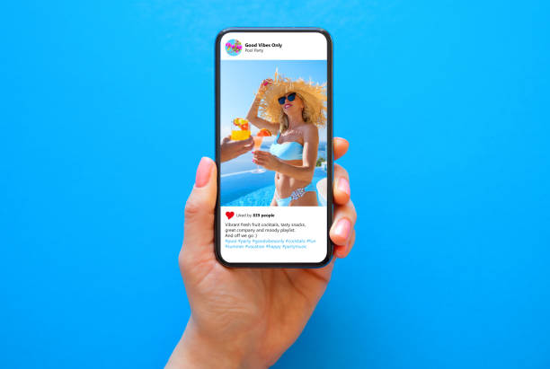 istock Mobile phone on blue background with shared photo on social media app 1385630117