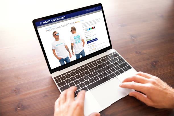 istock Man creating custom design t-shirt on print on demand website 1385630136