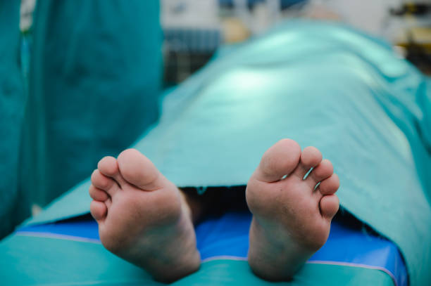corpse foot on hospital table, health care medicine concept and life death insurance business stock photo
