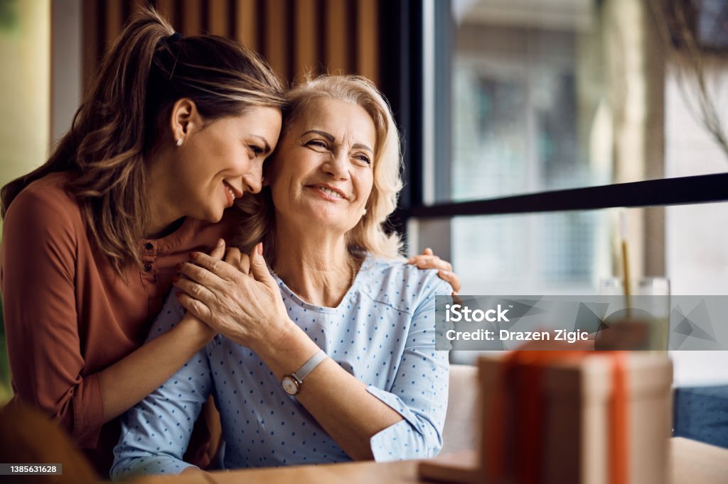 Thank you for all the love you have given me, Mom! Happy senior woman enjoying in daughter's affection on Mother's day. Family Stock Photo